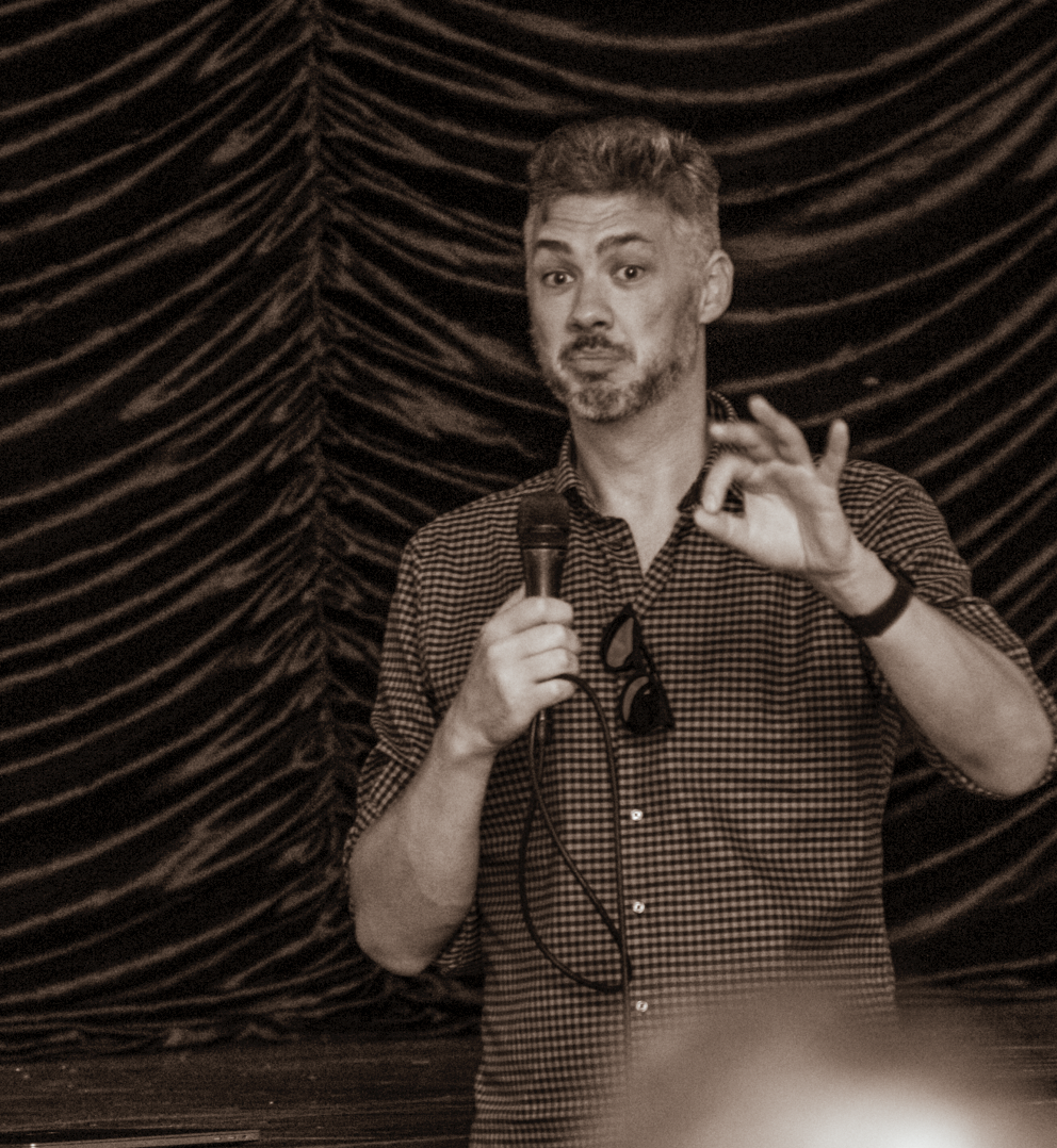 Daniel Fox delivering a keynote, microphone in hand