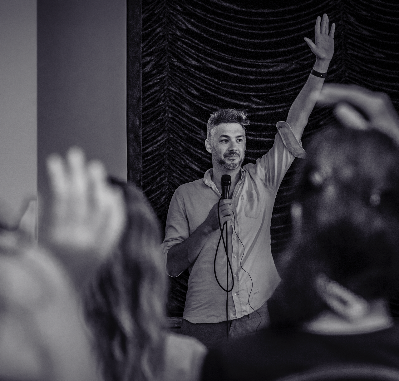 Daniel Fox on stage as the audience raises their hands
